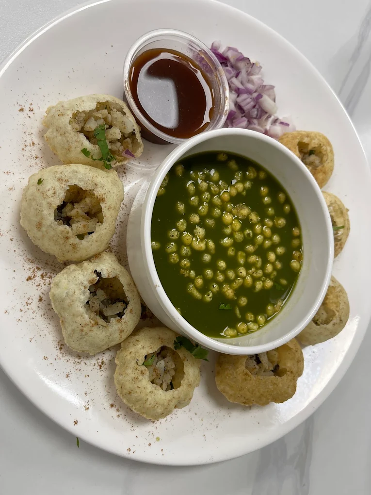 Fresh Pani Puri platter with spiced mint water, tamarind chutney, onions and sev