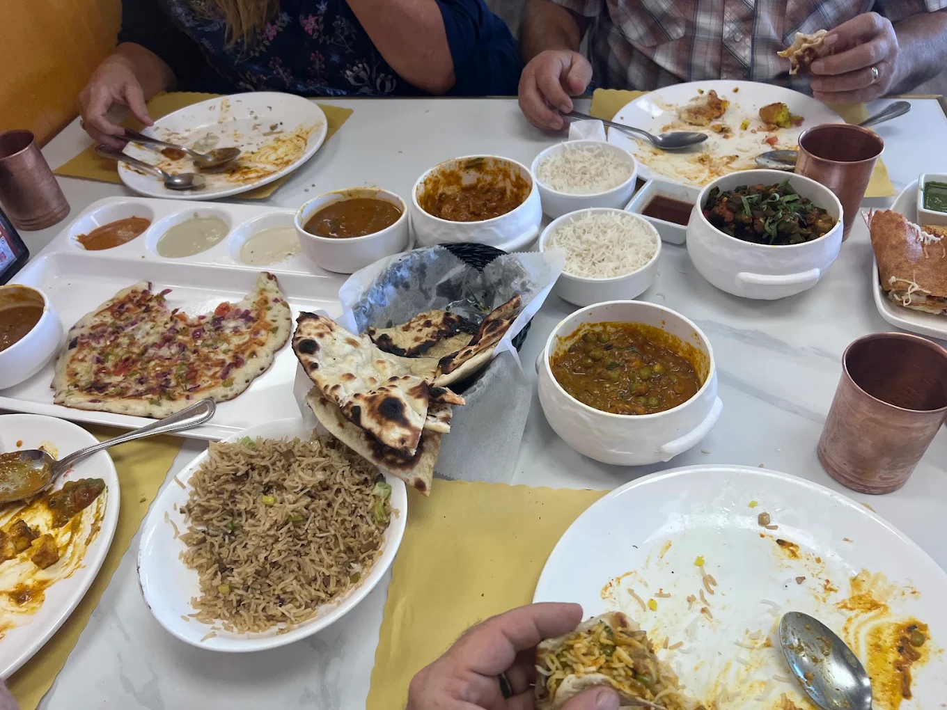 Family feast at Honest: dosas, uttapam, biryani, curries, naan, and copper tumblers