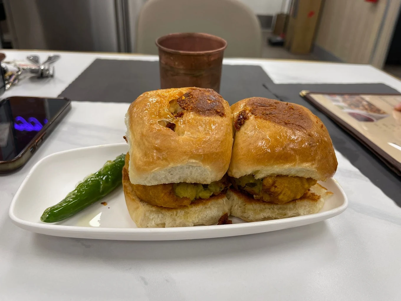 Hot Vada Pav served fresh on a toasted bun with spiced potato vada and green chili