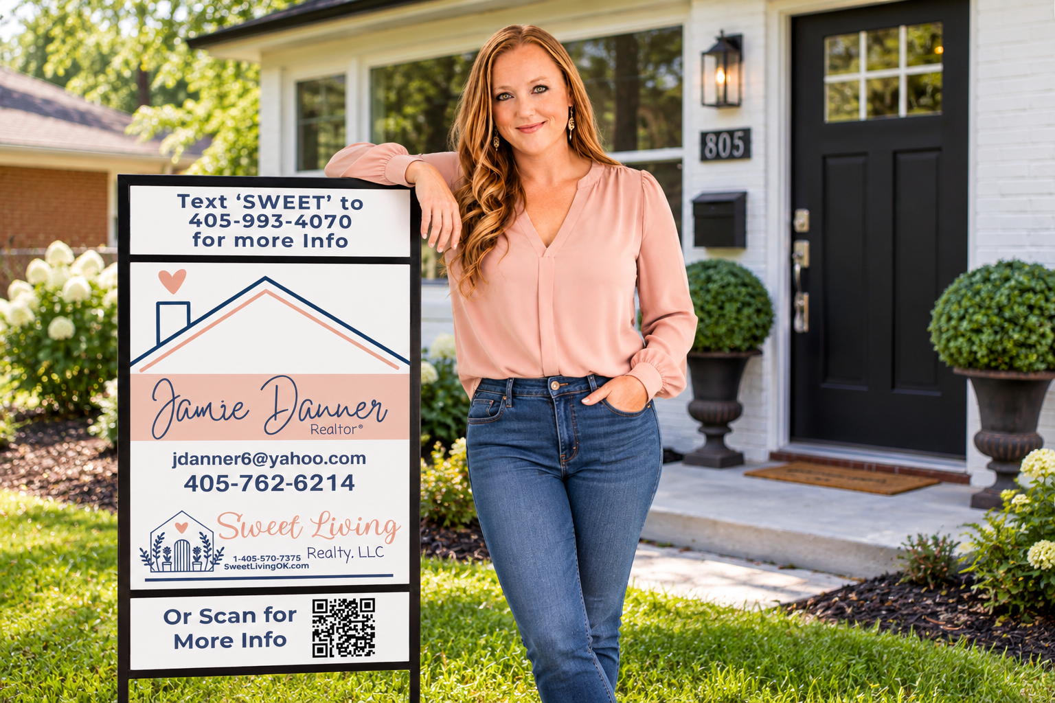 Jamie Danner standing beside her Sweet Living Realty yard sign with Text-for-Info and QR code