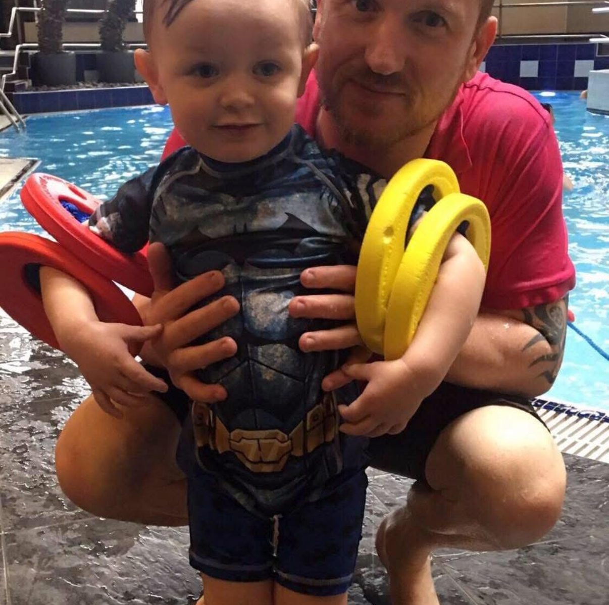 Benjamin Hamlett teaching a young child in the water during a swimming lesson