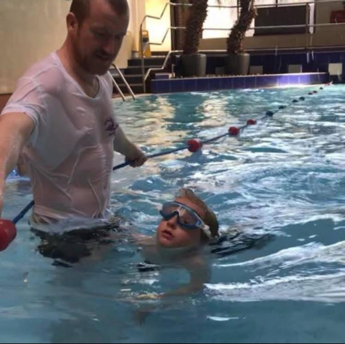 Benjamin Hamlett providing in-water tuition and technique guidance during a swimming lesson