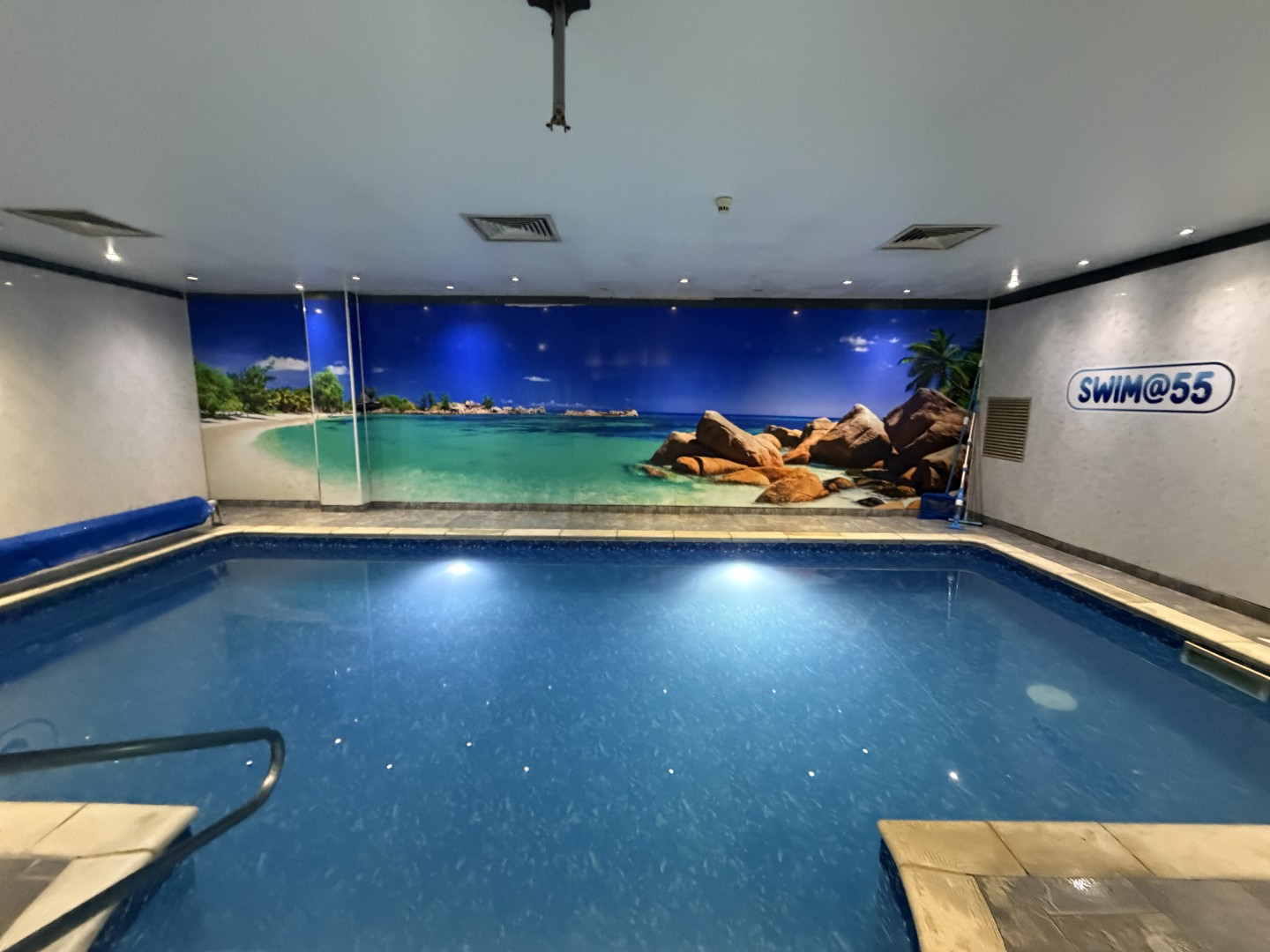 The Swim 55 pool interior looking towards the beach mural during a swimming lesson