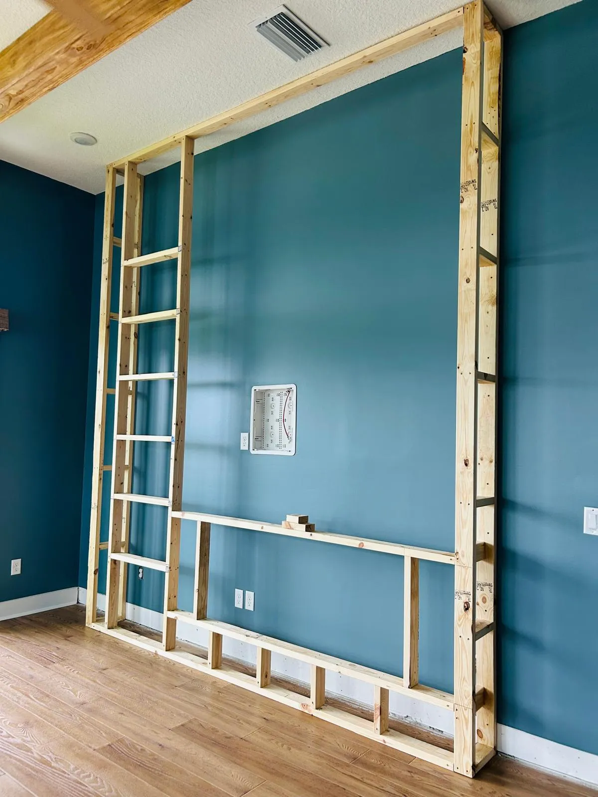 Custom wood framing for living room feature wall and fireplace by JS Remodeling & Handyman