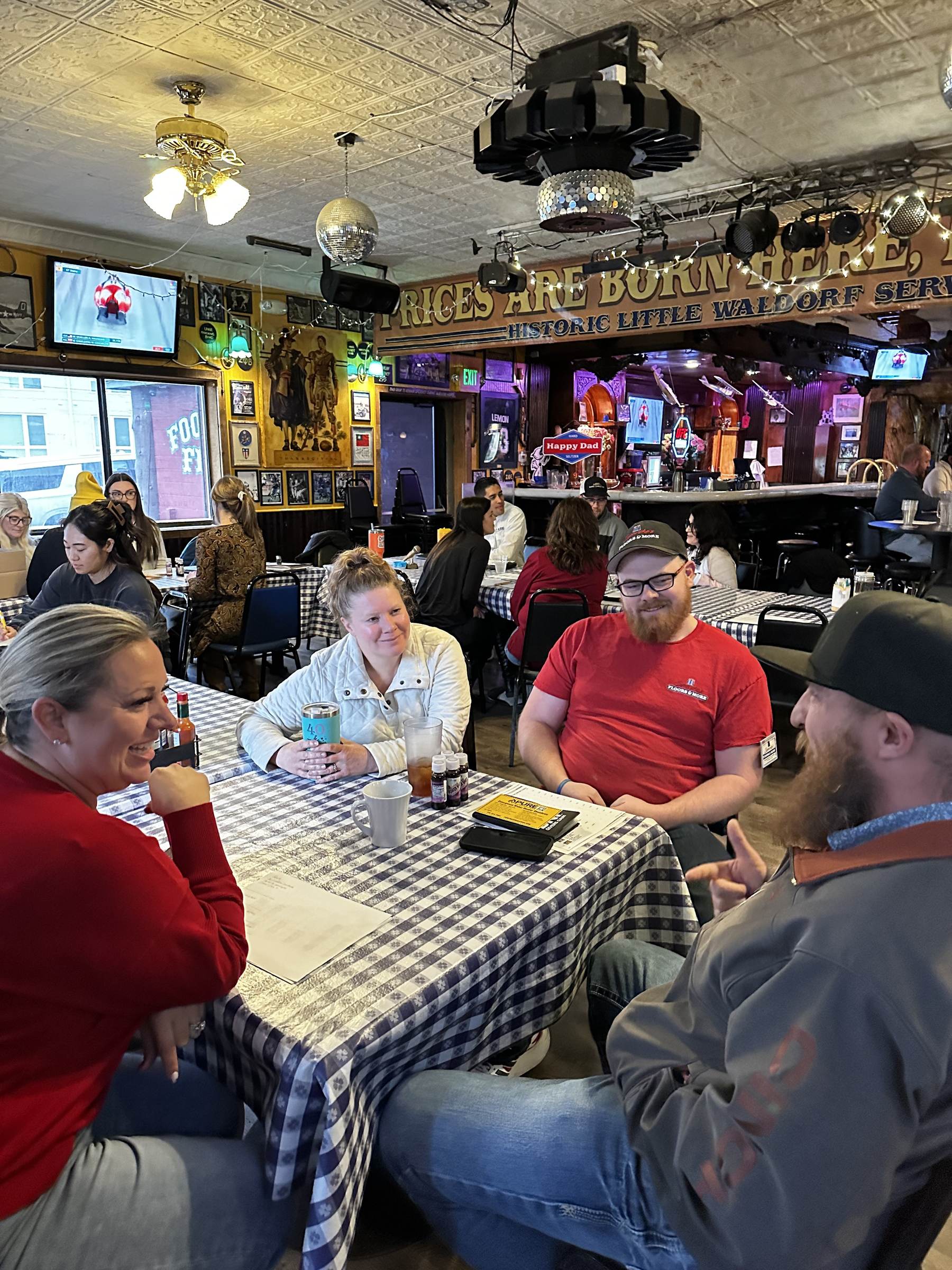 Chapter members smiling and connecting over coffee at the meeting table
