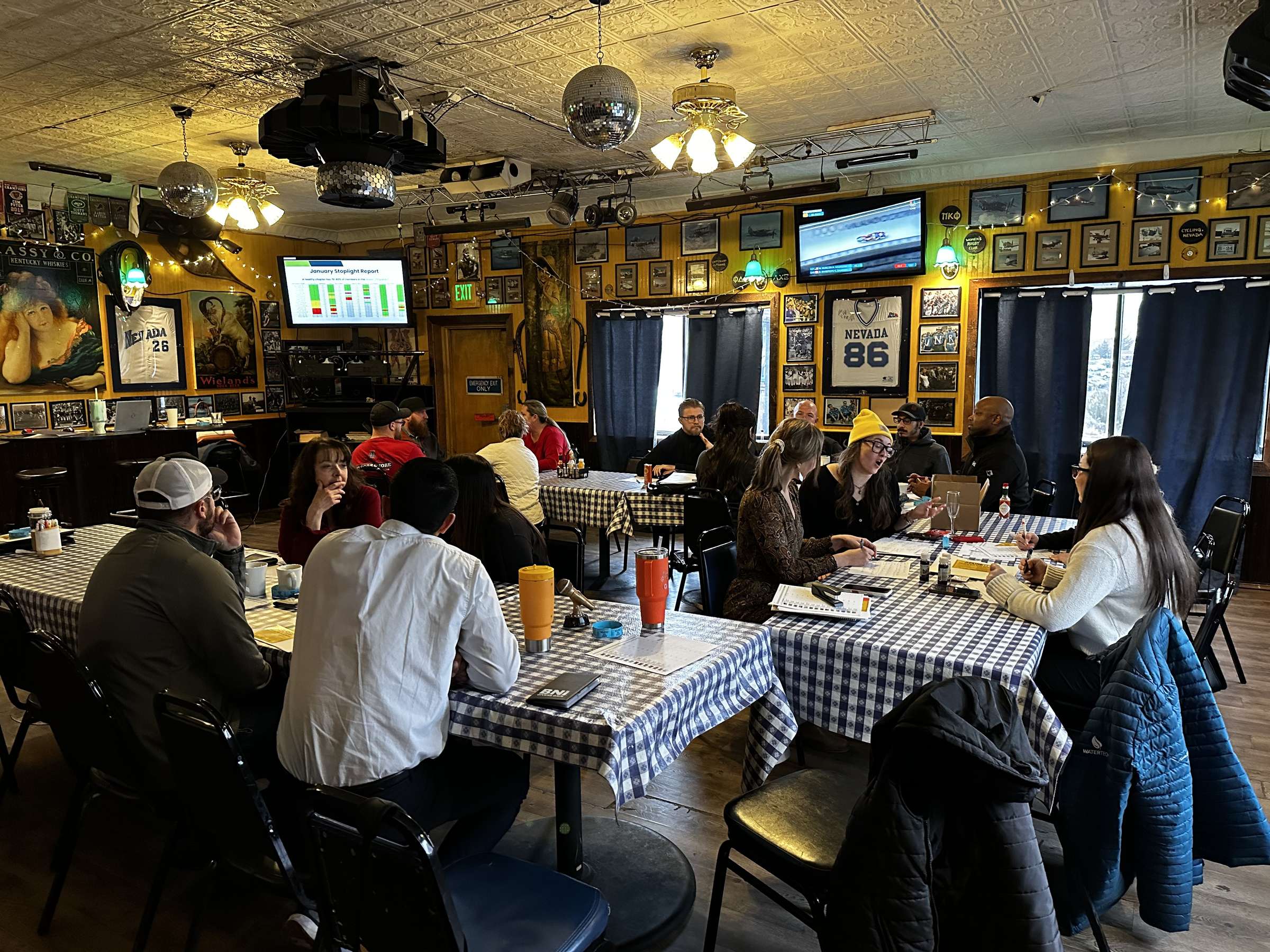 Members seated across gingham breakfast tables during an active chapter meeting at Little Waldorf Saloon