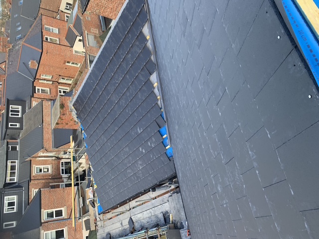 A roof valley repair with neatly laid tiles and a clean, watertight junction.