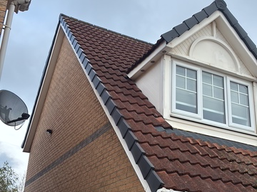 Modern dry verge caps fitted along the gable roofline to secure edge tiles neatly.