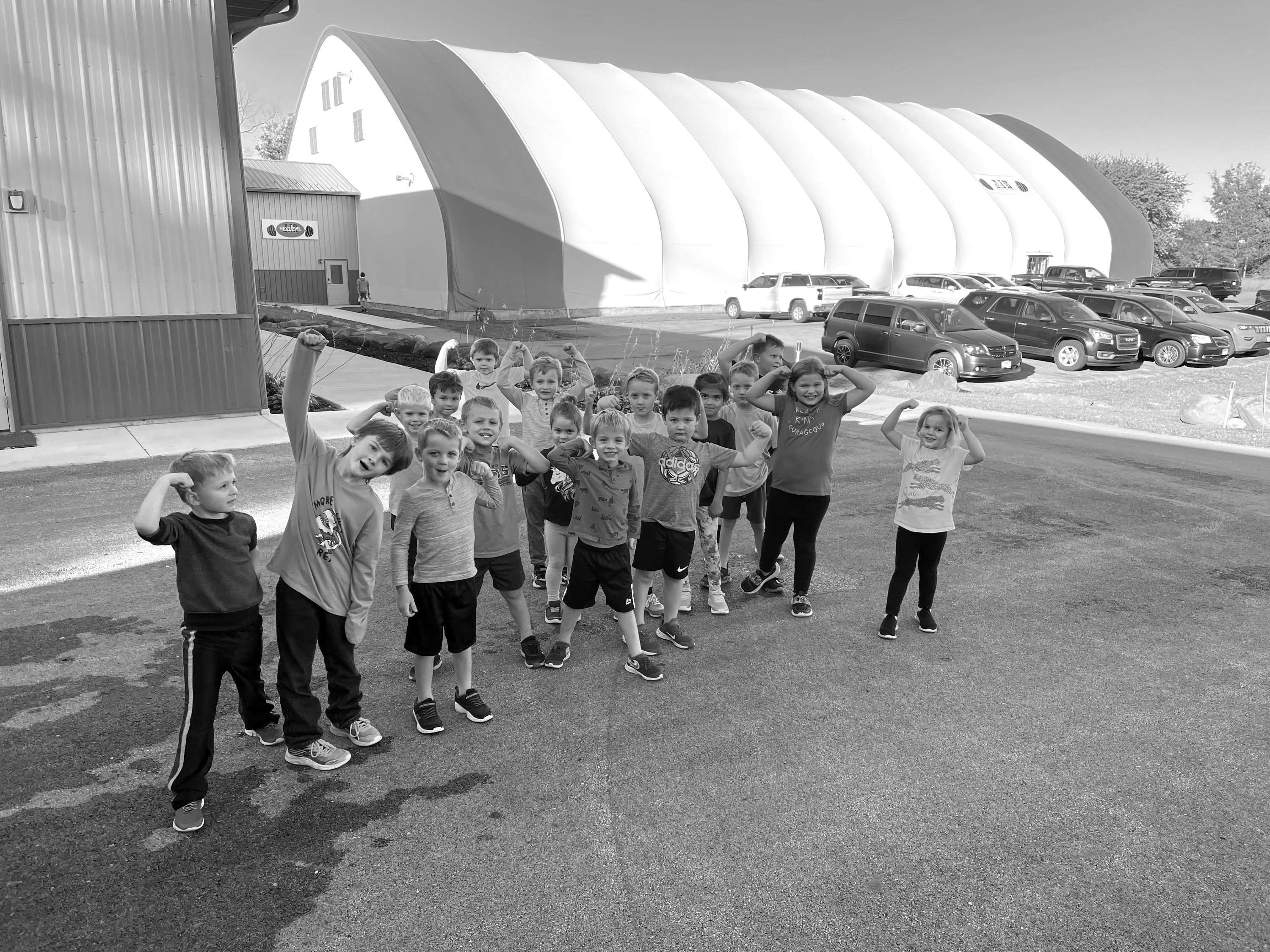 Youth athletes running and playing group activities inside the JJR LaSalle sports dome