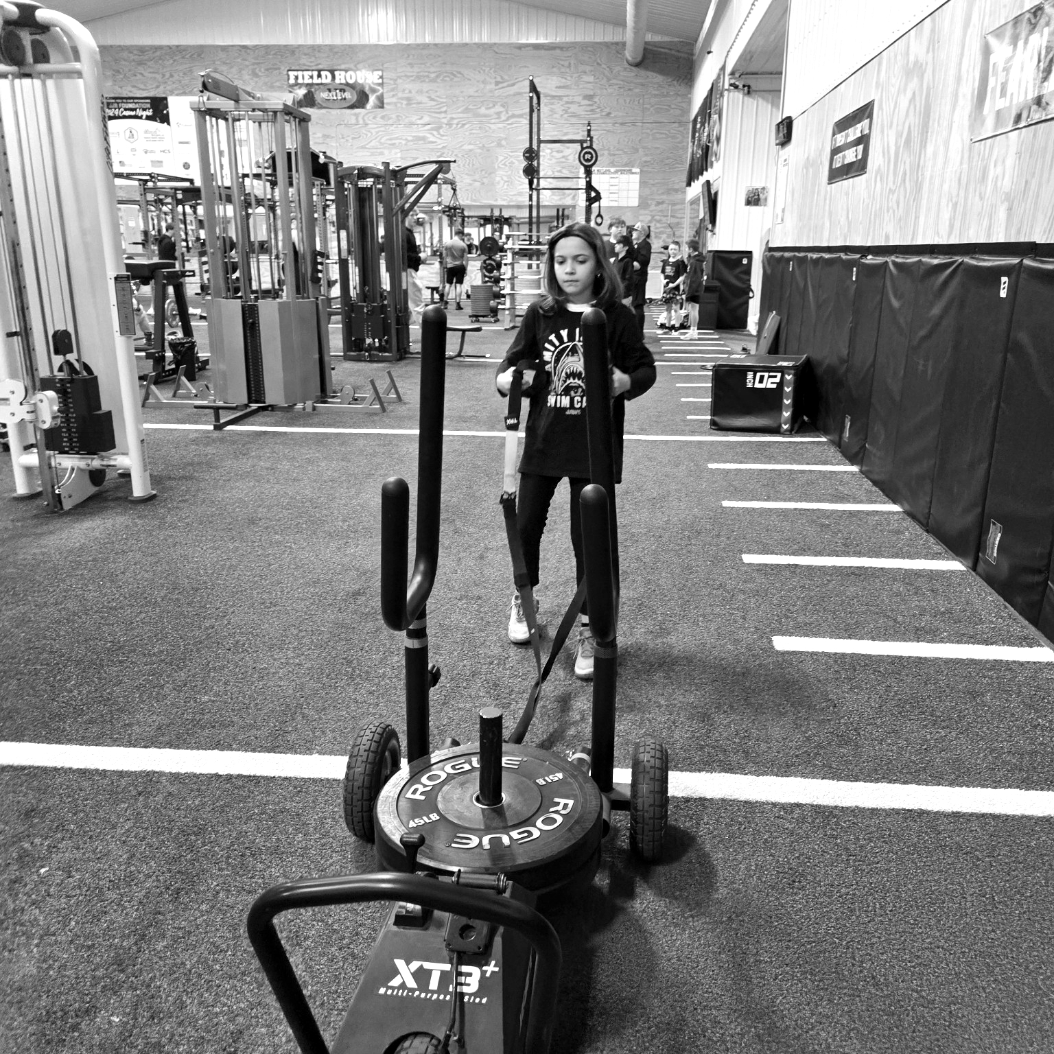 Athlete training with sled push on the JJR LaSalle dome turf