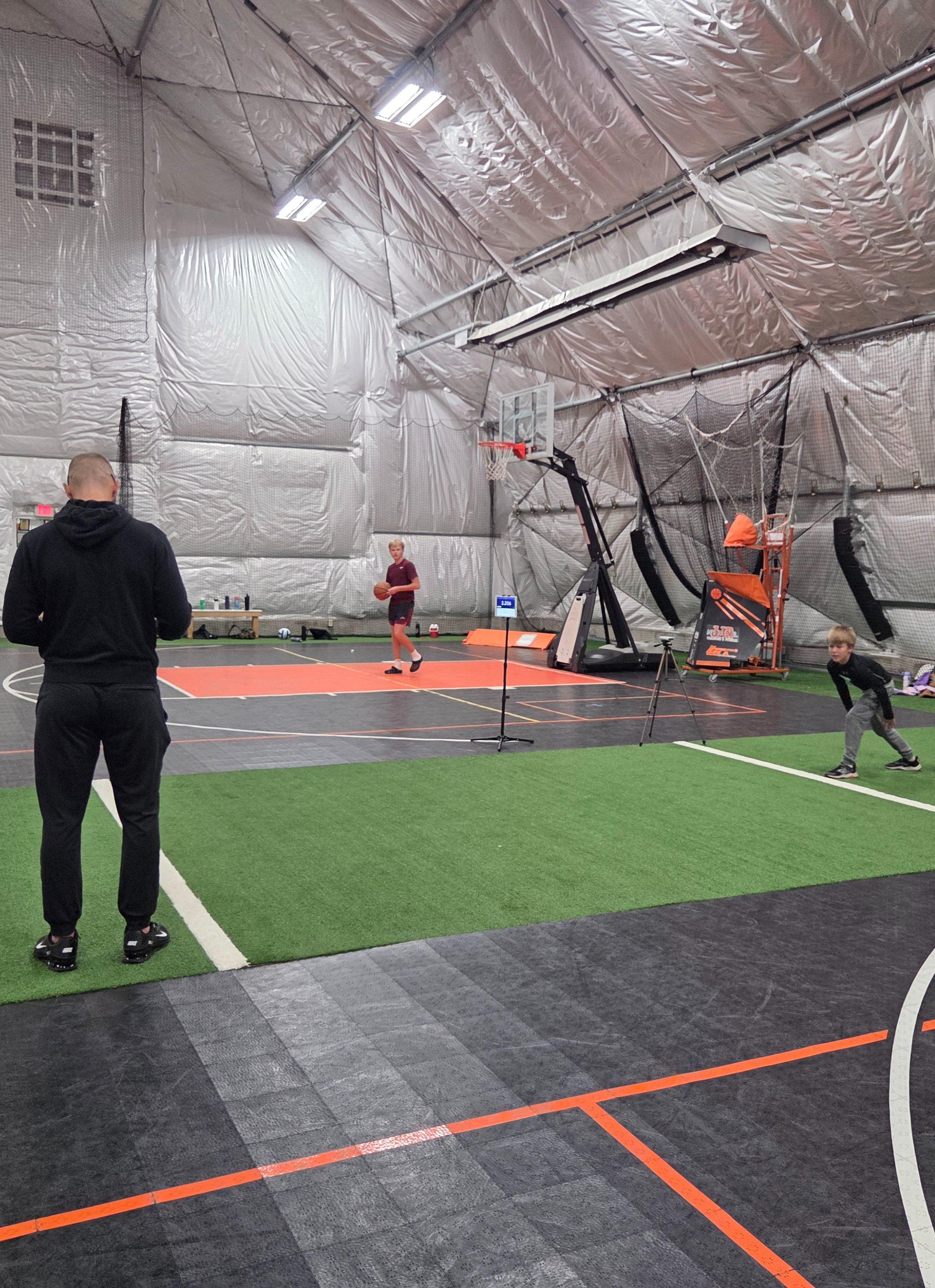JJR coach leading athletes through training drills on the LaSalle dome turf