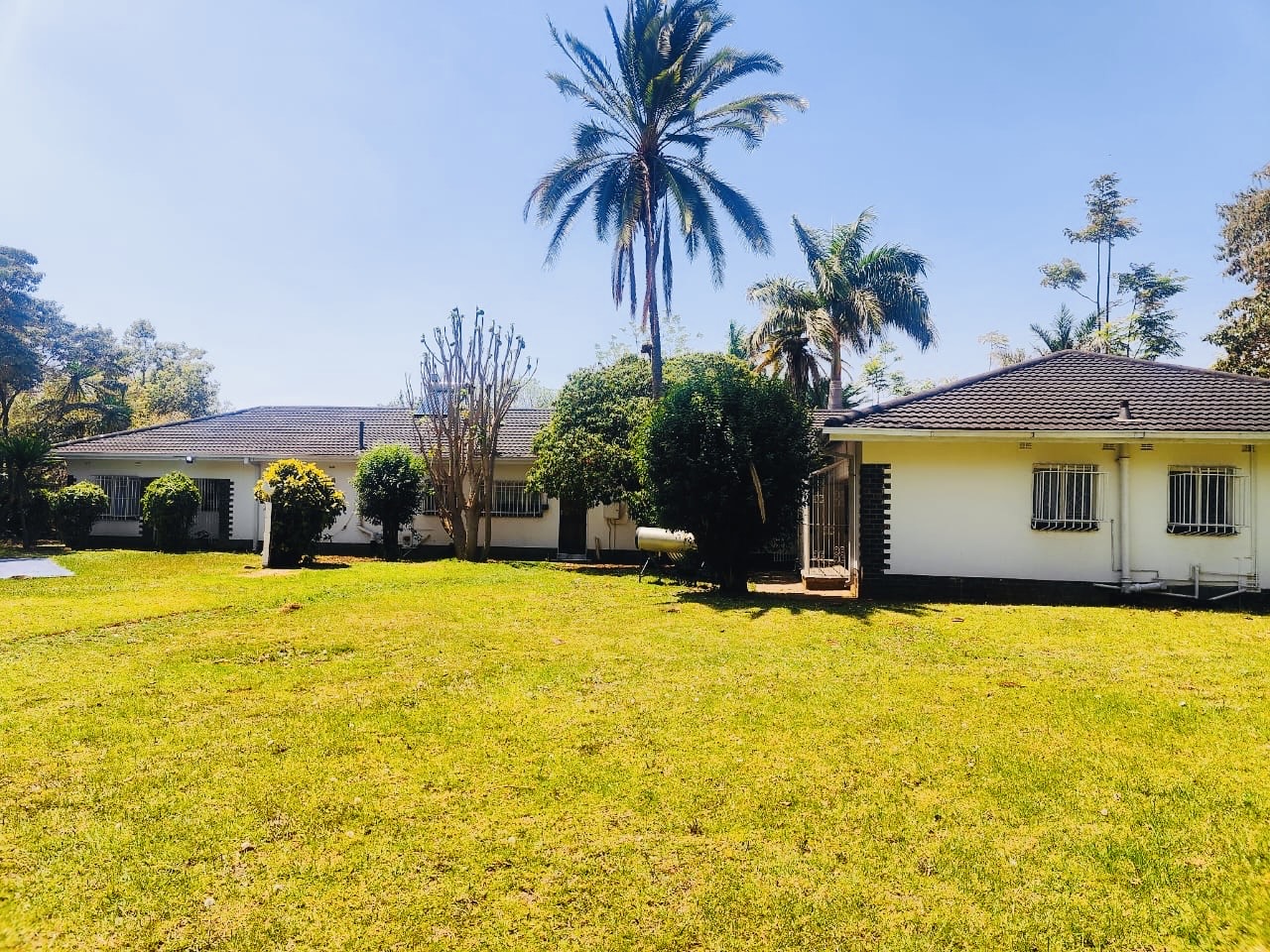 Expansive green lawns and residence exterior