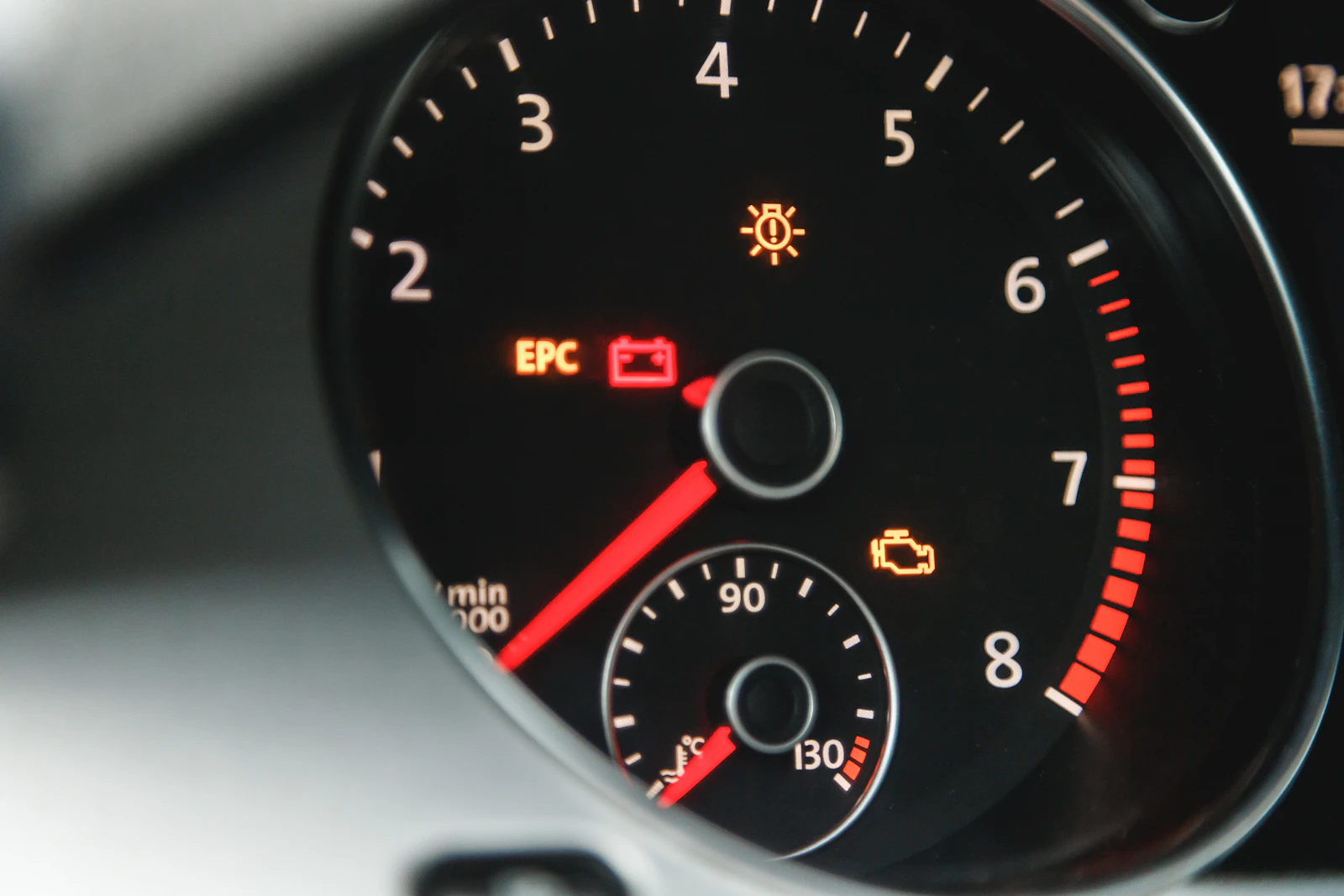 Amber check engine warning light on a car dashboard