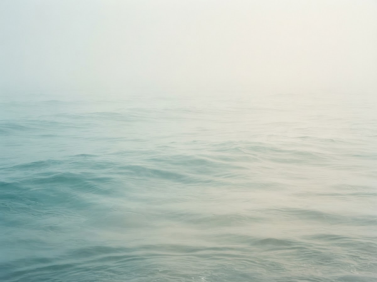 Decorative misty ocean surface in muted teal and cream