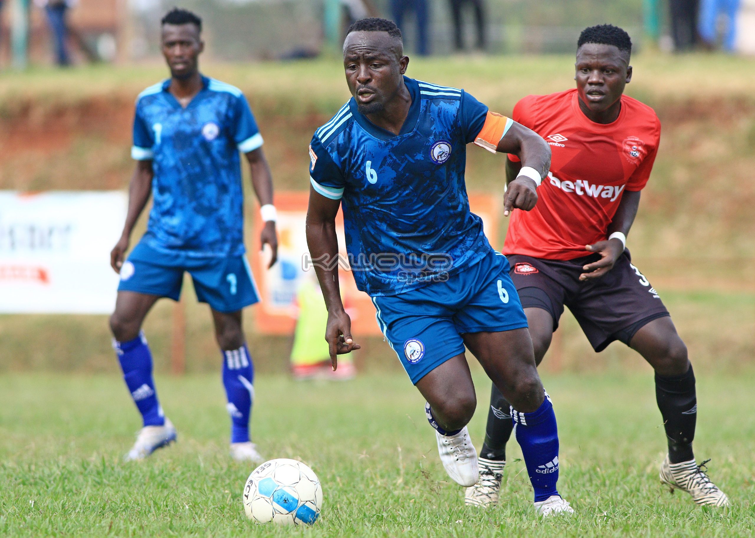 Tonny Mawejje in a green Police FC football kit on the pitch during a match, career archive.