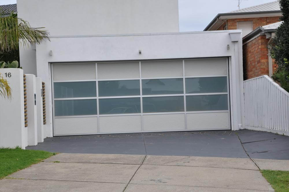 Custom sectional garage door with aluminium and window highlights, Dandenong Garage Doors installation