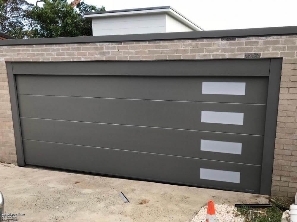 Insulated garage door with window highlights and modern design.