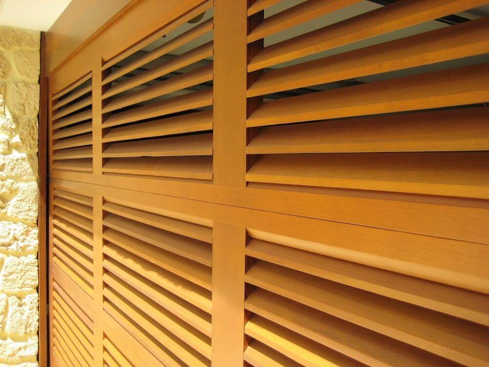 Wooden louvered garage door design with overlayed boards
