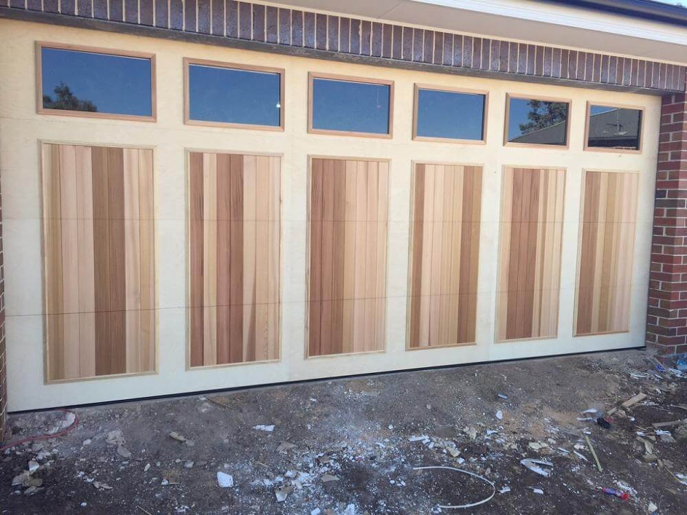 Carriage panel garage door with six panels and highlight windows, Dandenong Garage Doors installation.