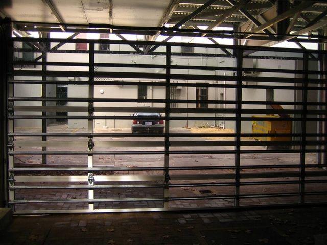 Aluminium sectional garage door with acrylic inserts and carriage panels