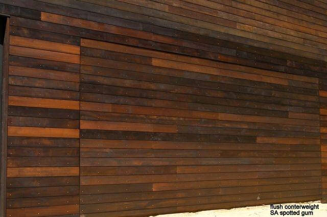 Flush mounted Spotted Gum tilt garage door design and installation by Dandenong Garage Doors.