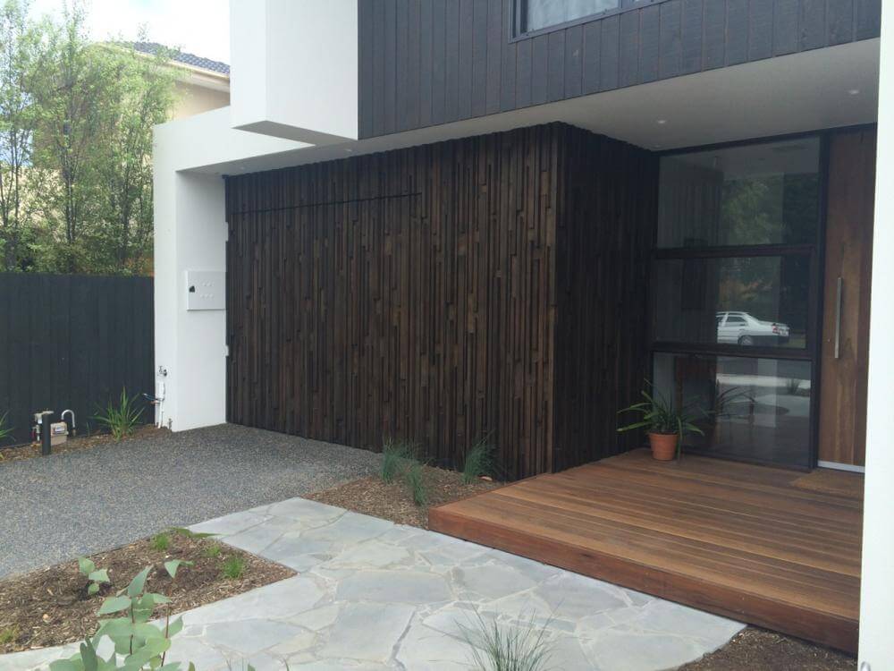 Vertical timber garage door with overlayed boards and custom design.