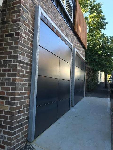 Corten front garage door installation with carriage panels and aluminium strappings