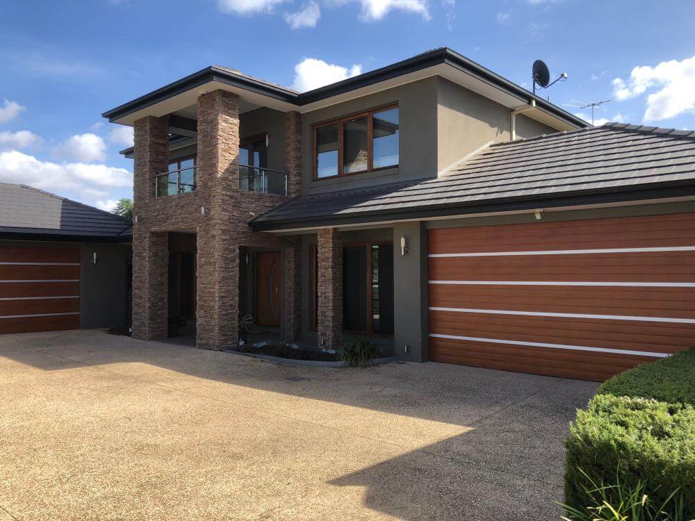Anodised aluminium strappings and timber garage door design in Dandenong, VIC.