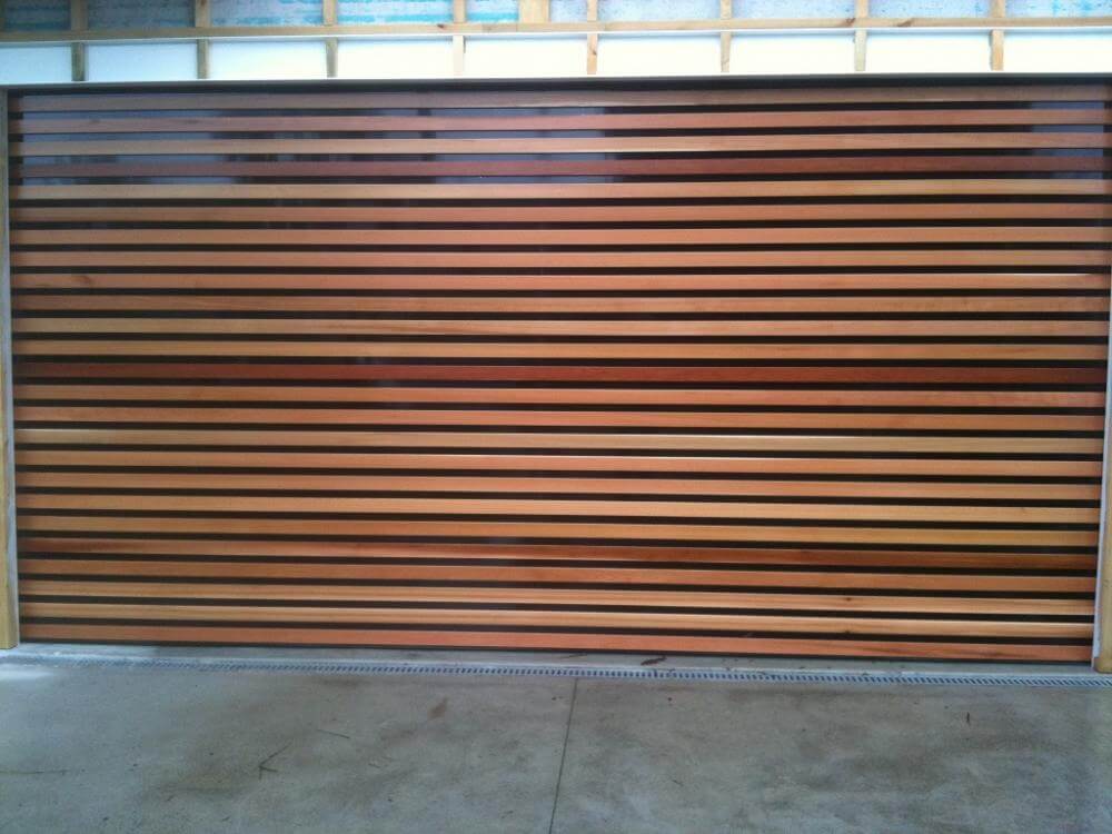 Timber batten garage door with Ali backing and overlayed boards design.