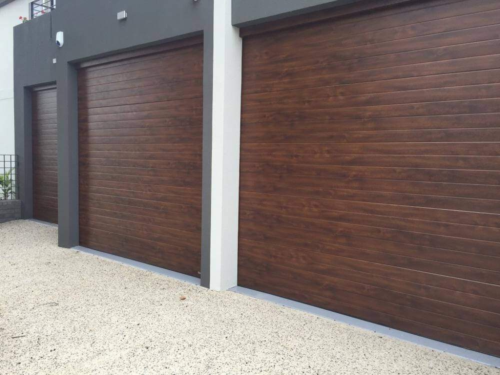 Insulated timber look garage doors and horizontal hardwood design.