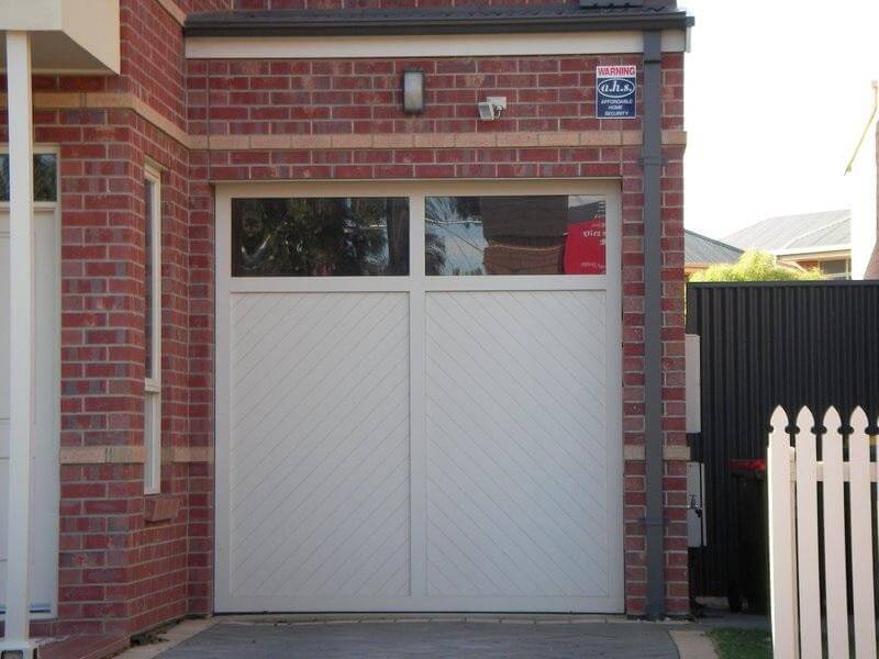 Timber carriage panel garage door design with windows