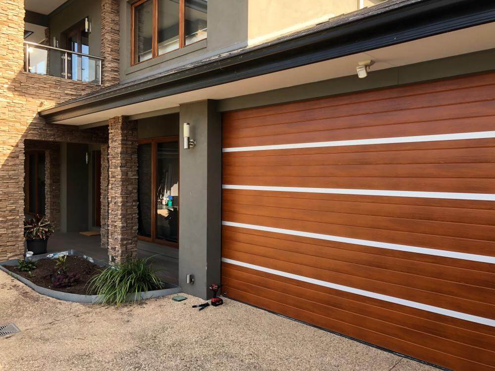 Anodised aluminium strappings and timber garage door design inspiration.