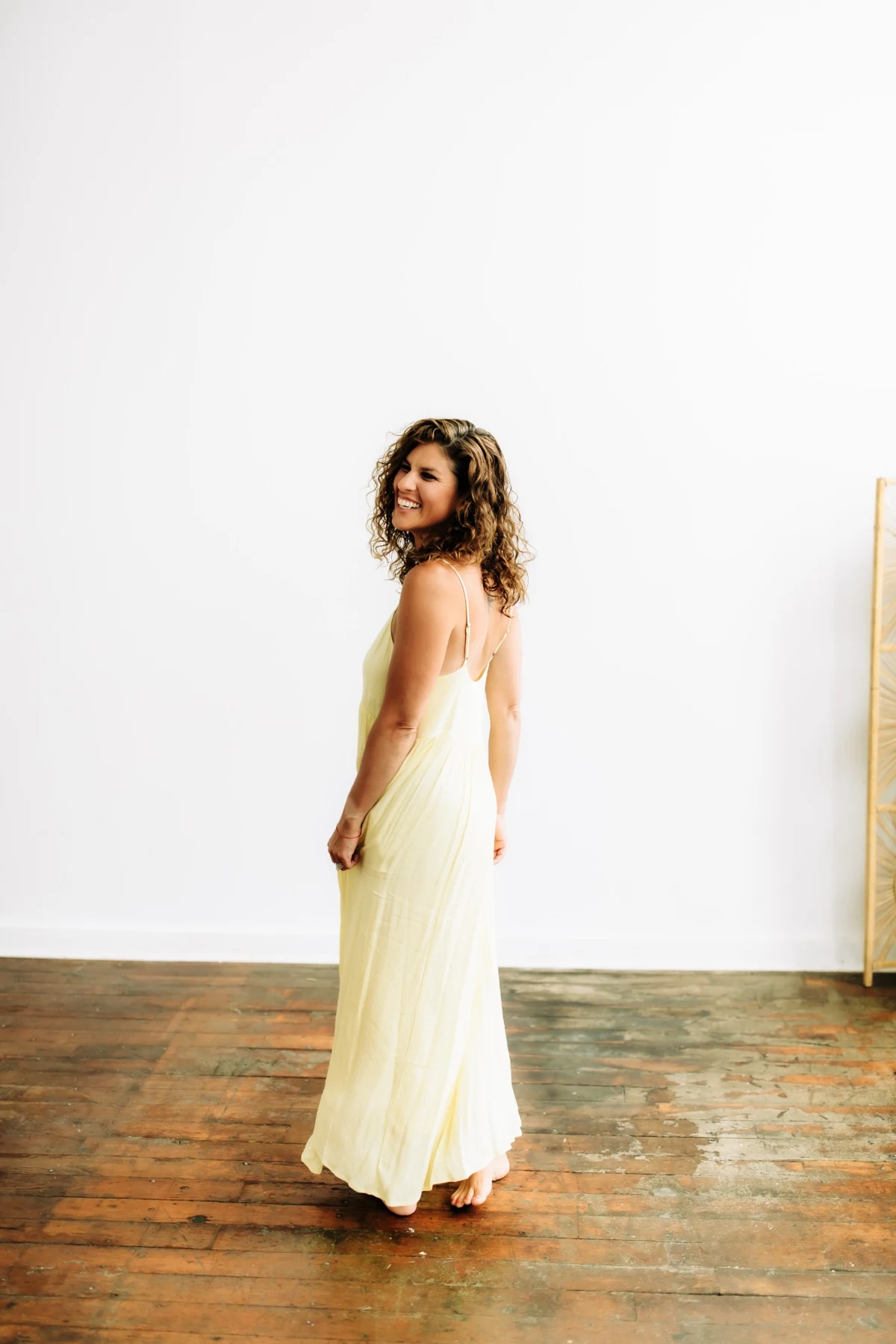 Rachel Krall smiling in a soft yellow dress