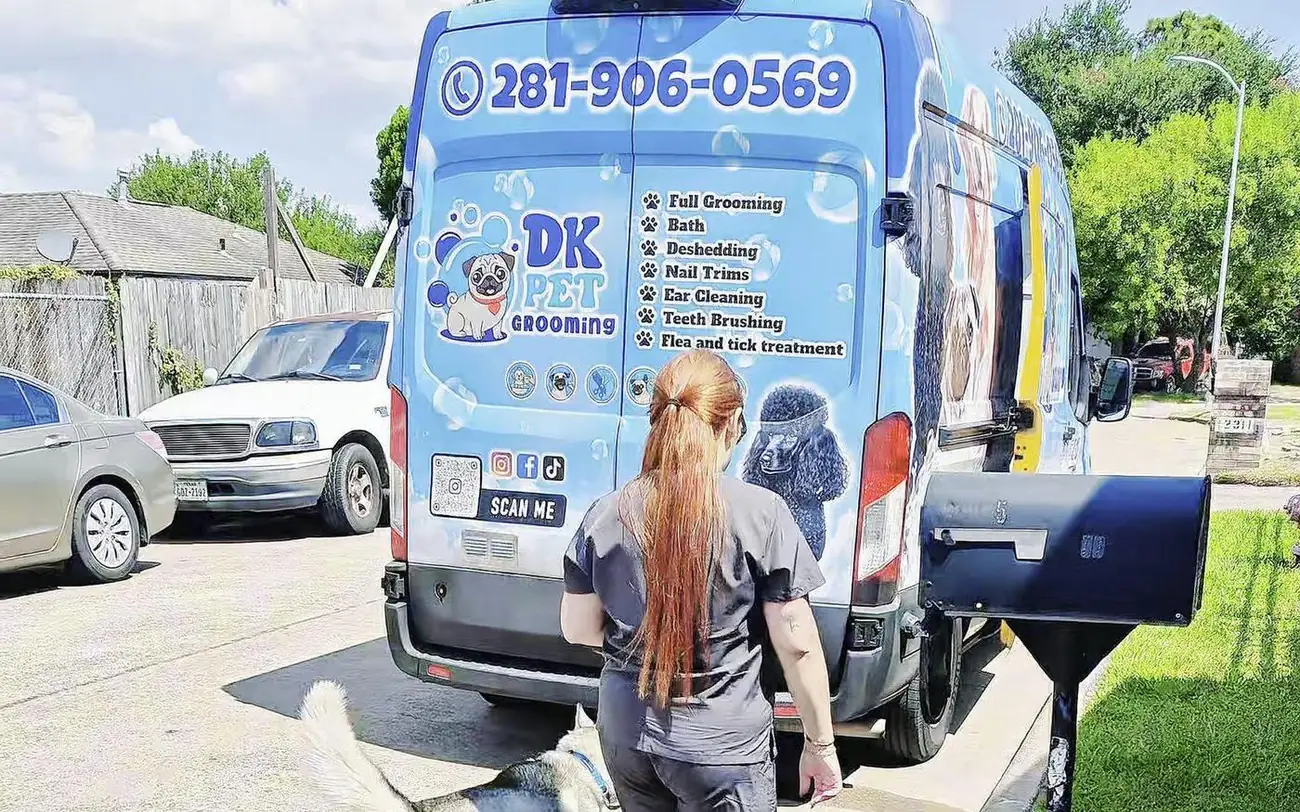 DK Pet Grooming van parked at a customer's home in Houston