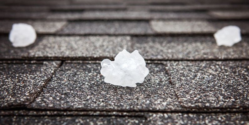 Hail damage on a roof requiring storm restoration