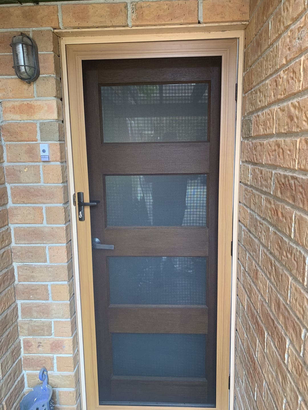 Security screen door fitted over panelled entrance door