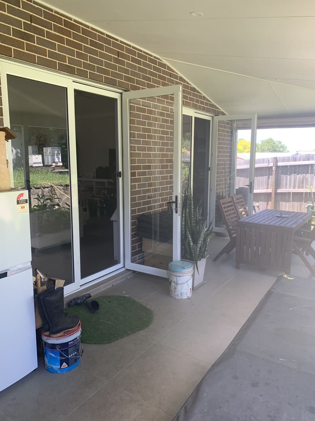 Multi-panel outdoor patio sliding screen doors installed on outdoor living area