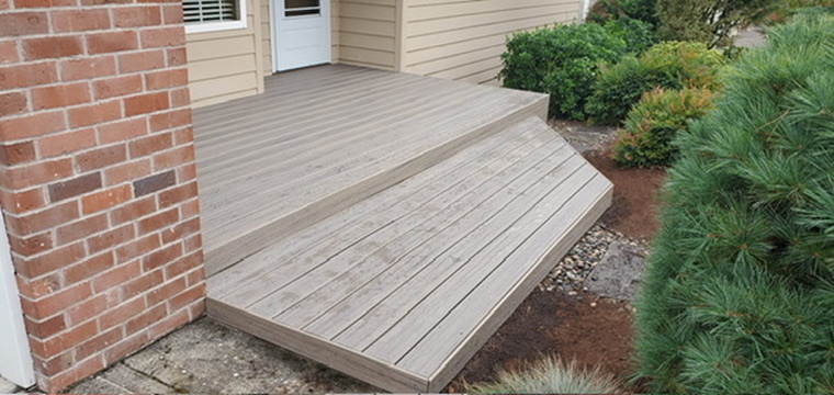 Mirella's modern gray composite front porch deck with custom angled step and trim border