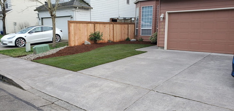 Brand new cedar privacy fence with fresh bark mulch bed, crisp lawn edging and front yard curb appeal