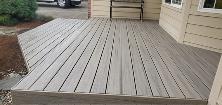 Completed front porch composite deck with seating bench, flush border trim and crisp miter joints