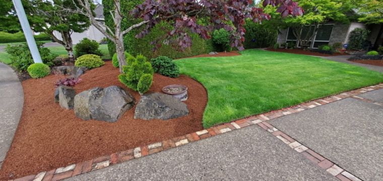 Crisp edging, rock features and fresh bark mulch