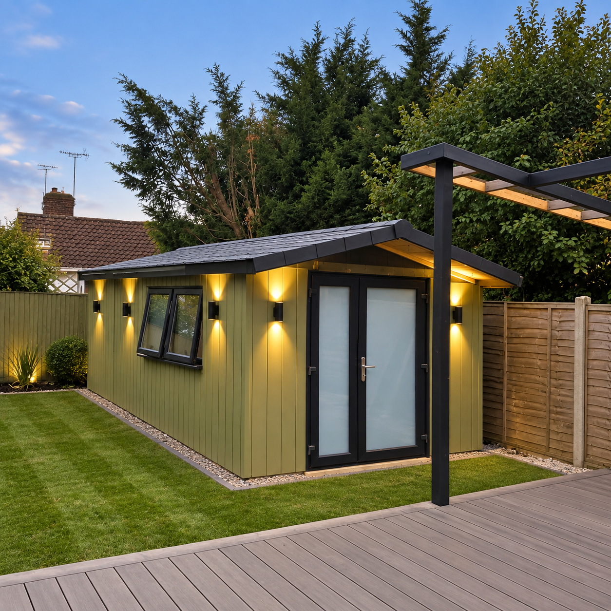 Sage green pitched roof garden studio with architectural sconces in Hassocks