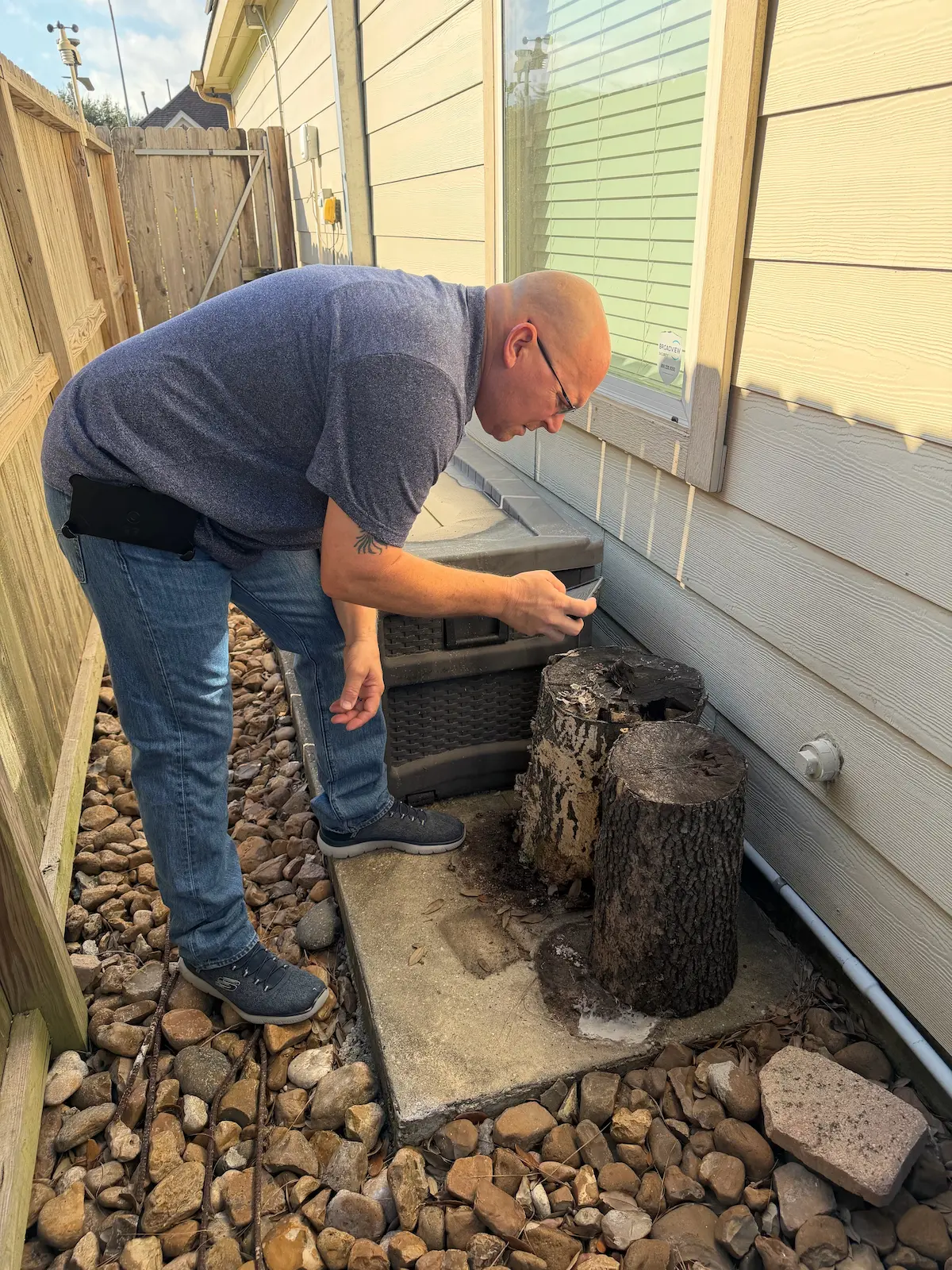 Dave Tague performing a wood-destroying insect (WDI) termite inspection outdoors near home exterior