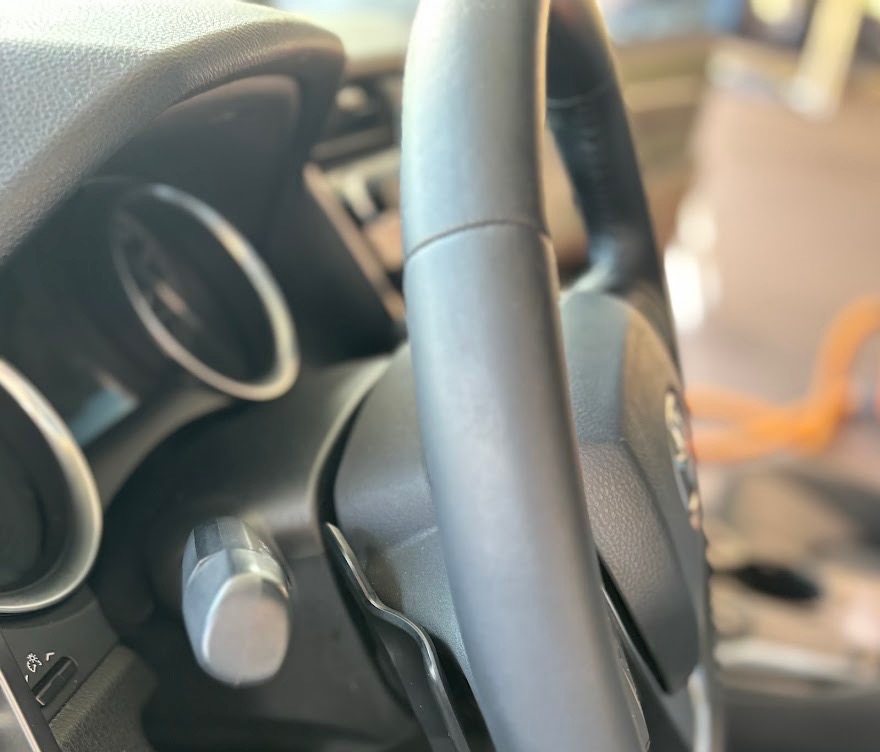 Steering wheel after detailing restored to OEM matte leather finish