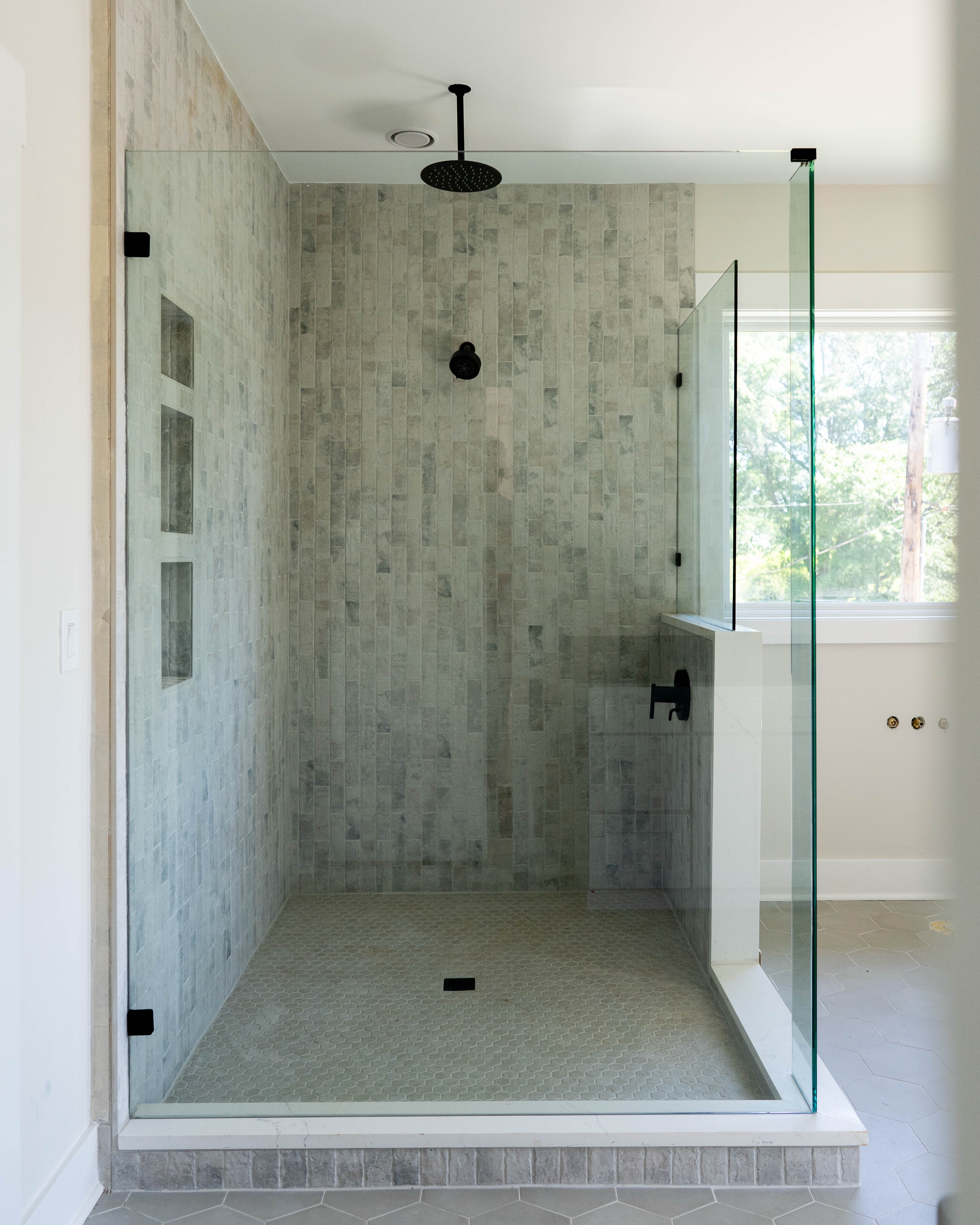 Custom frameless glass shower door with matte finish