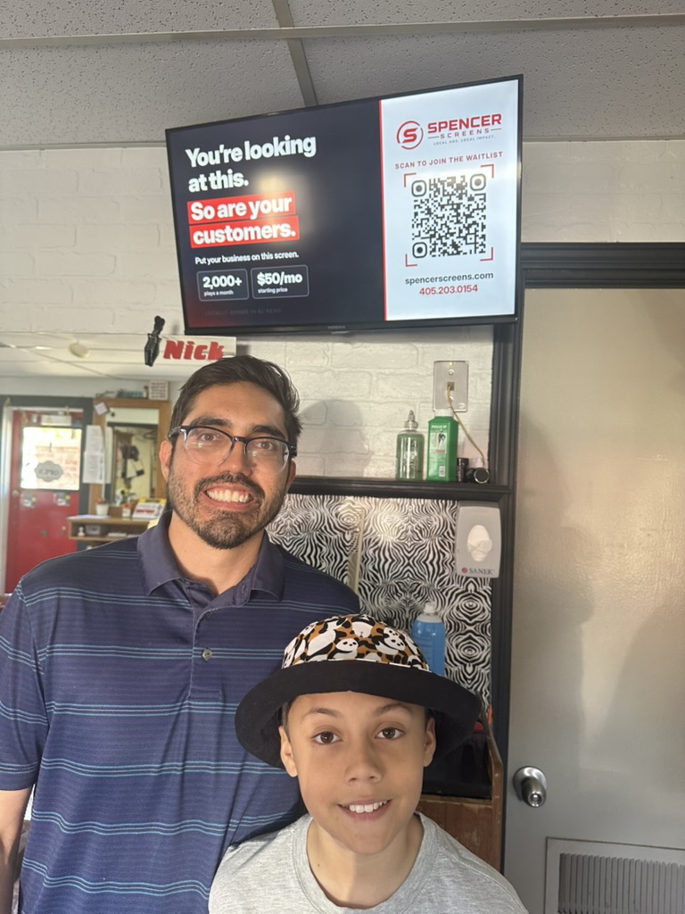 Spencer Screens live TV ad display mounted inside Nick's Barber Shop