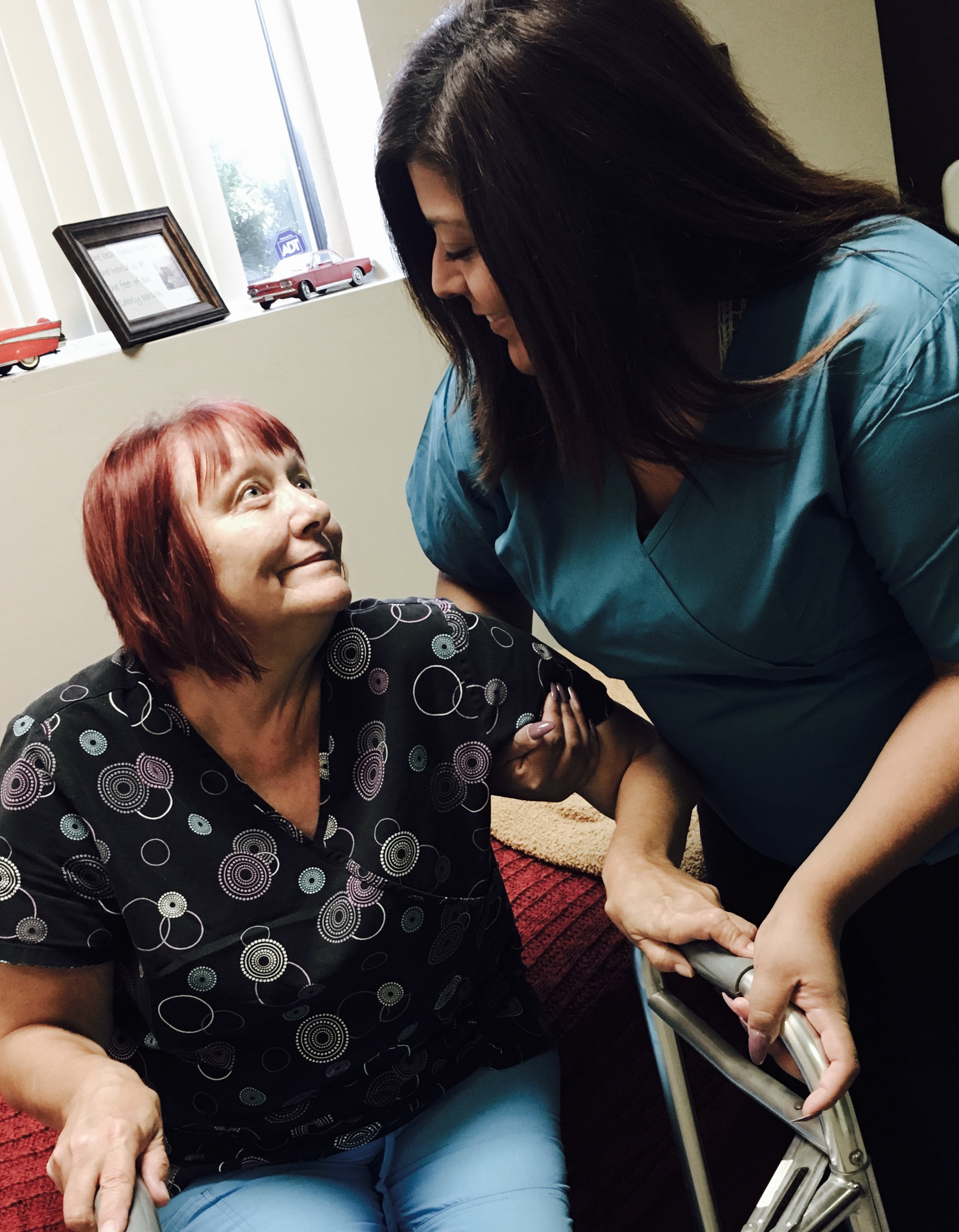 Friends Over Fifty caregiver warmly assisting a senior client with mobility in Romeoville