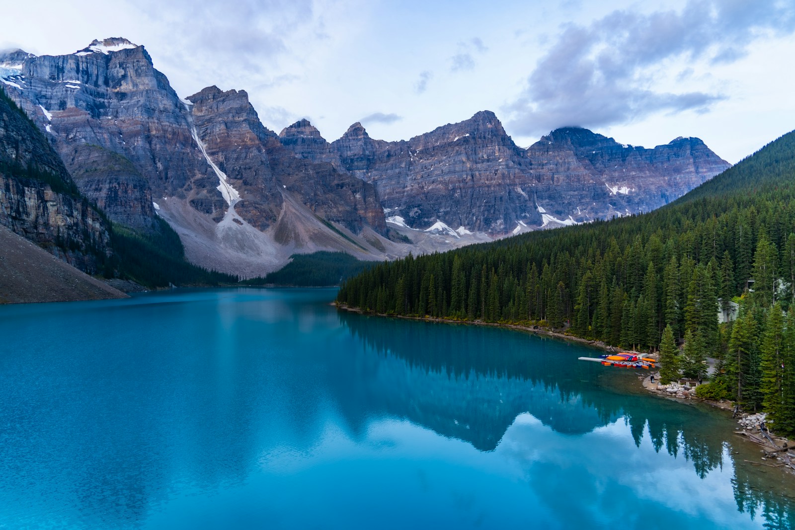 Lakeshore framed by green mountains