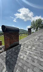 Custom fabricated arched black chimney cap and roof flashing by McCullough Roofing