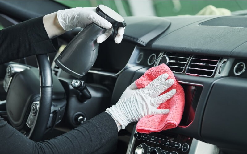 Interior dashboard and AC vent detailing with microfibre wipe and cleaner spray